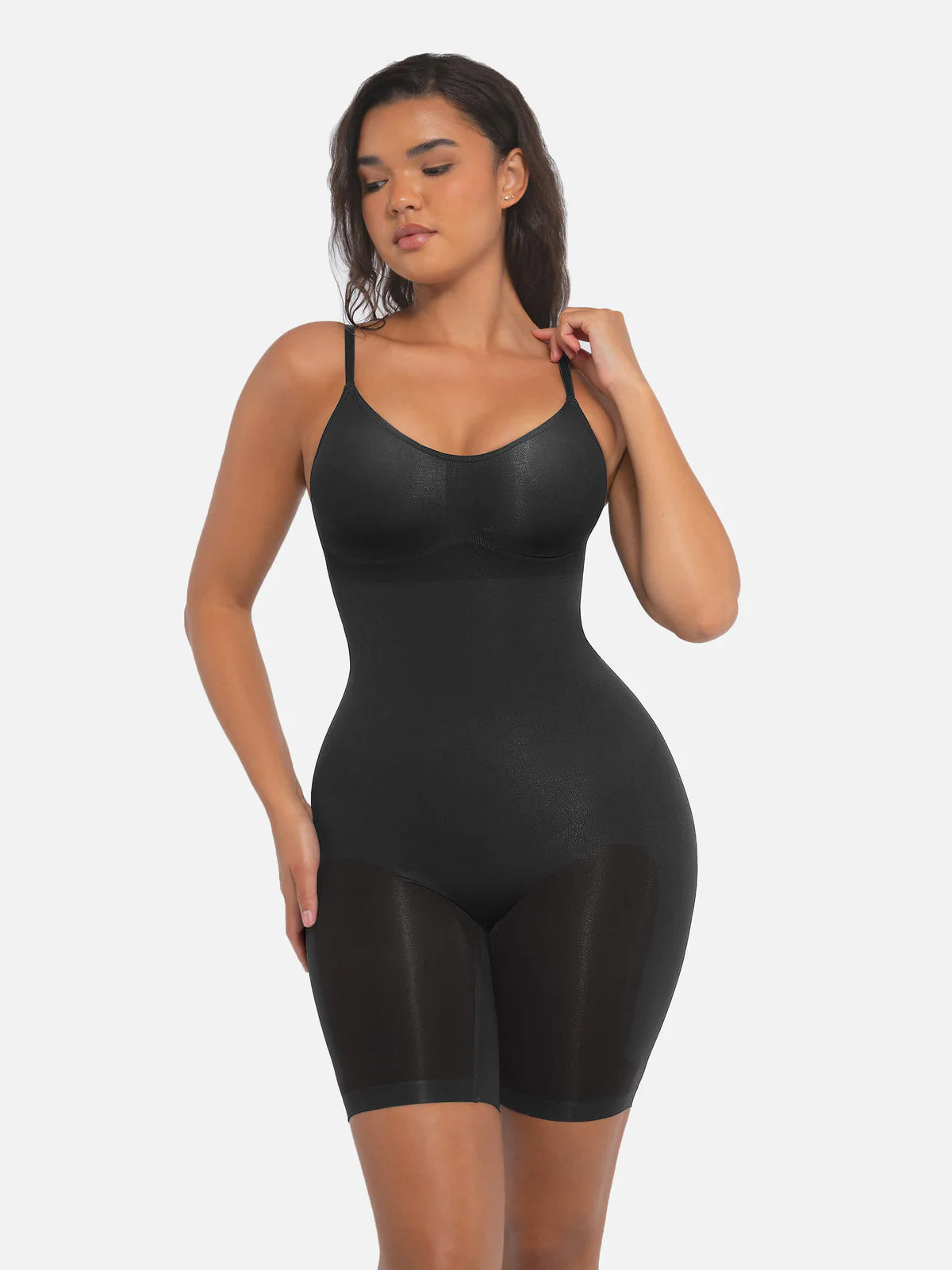 Person wearing a black shapewear bodysuit.