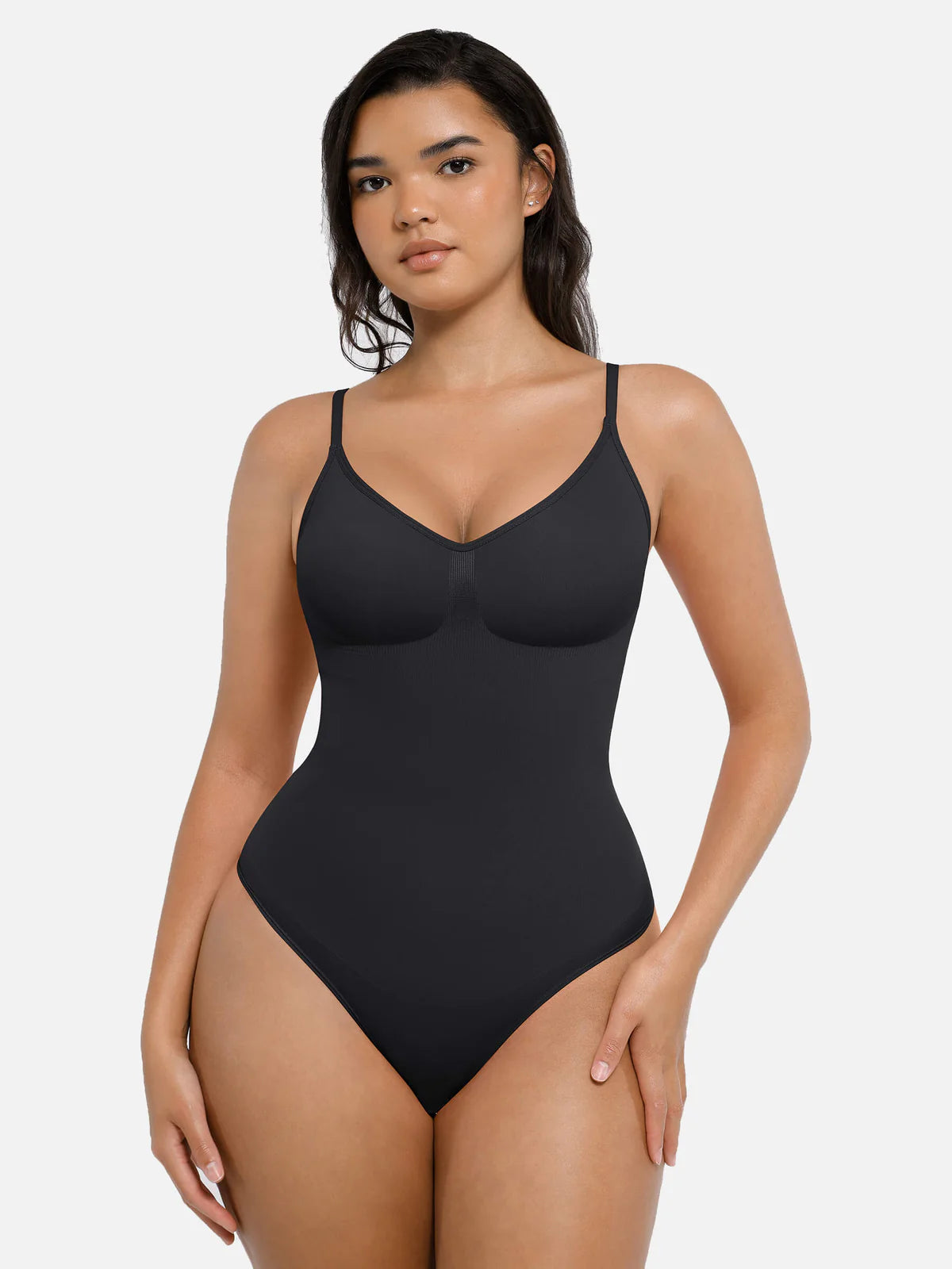 Person wearing a black shapewear bodysuit.